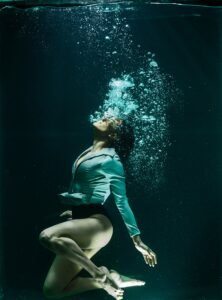 Depicting the inner struggle and resilience, the image portrays a woman underwater, a visual metaphor for the challenges faced during my mental health battles.